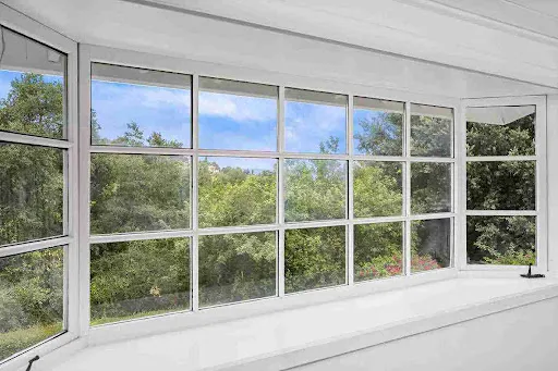 Window Replacement in Florida Built for Heat, Storms, and Insurance Large multi-panel window replacement in bright sunroom providing expanded views and enhanced home ventilation.